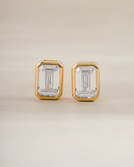 Gold emerald cut stud earrings by Sami Jewels shown from the front, highlighting their sleek rectangular gemstone design.