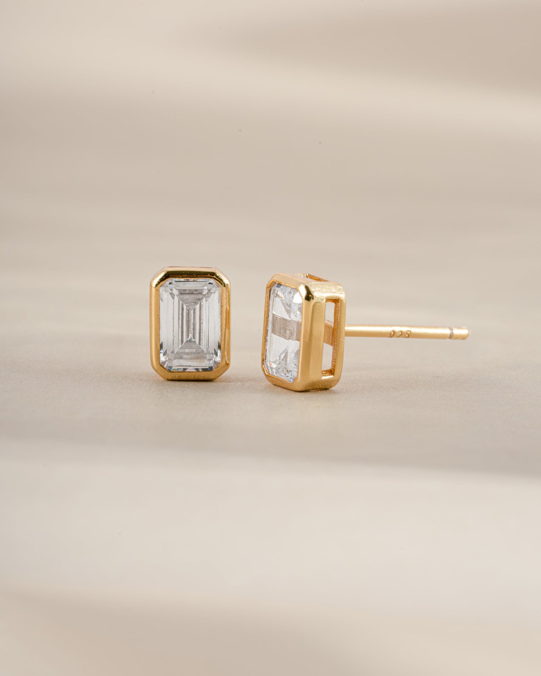 Gold emerald cut stud earrings from Sami Jewels featuring sleek, geometric gemstone design with a secure post back.
