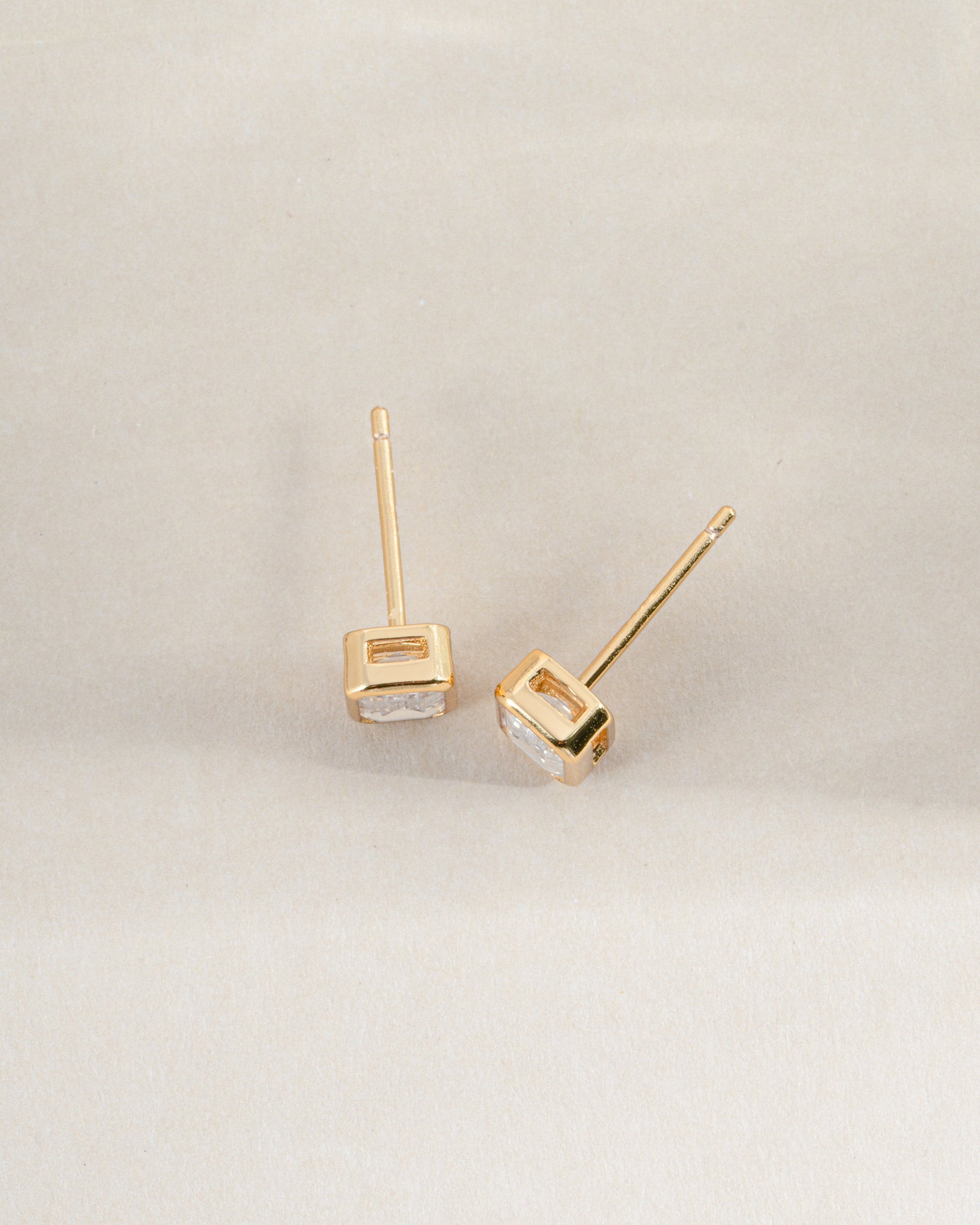 Gold Sami Jewels emerald cut stud earrings viewed from the top, showcasing their rectangular gemstone design.