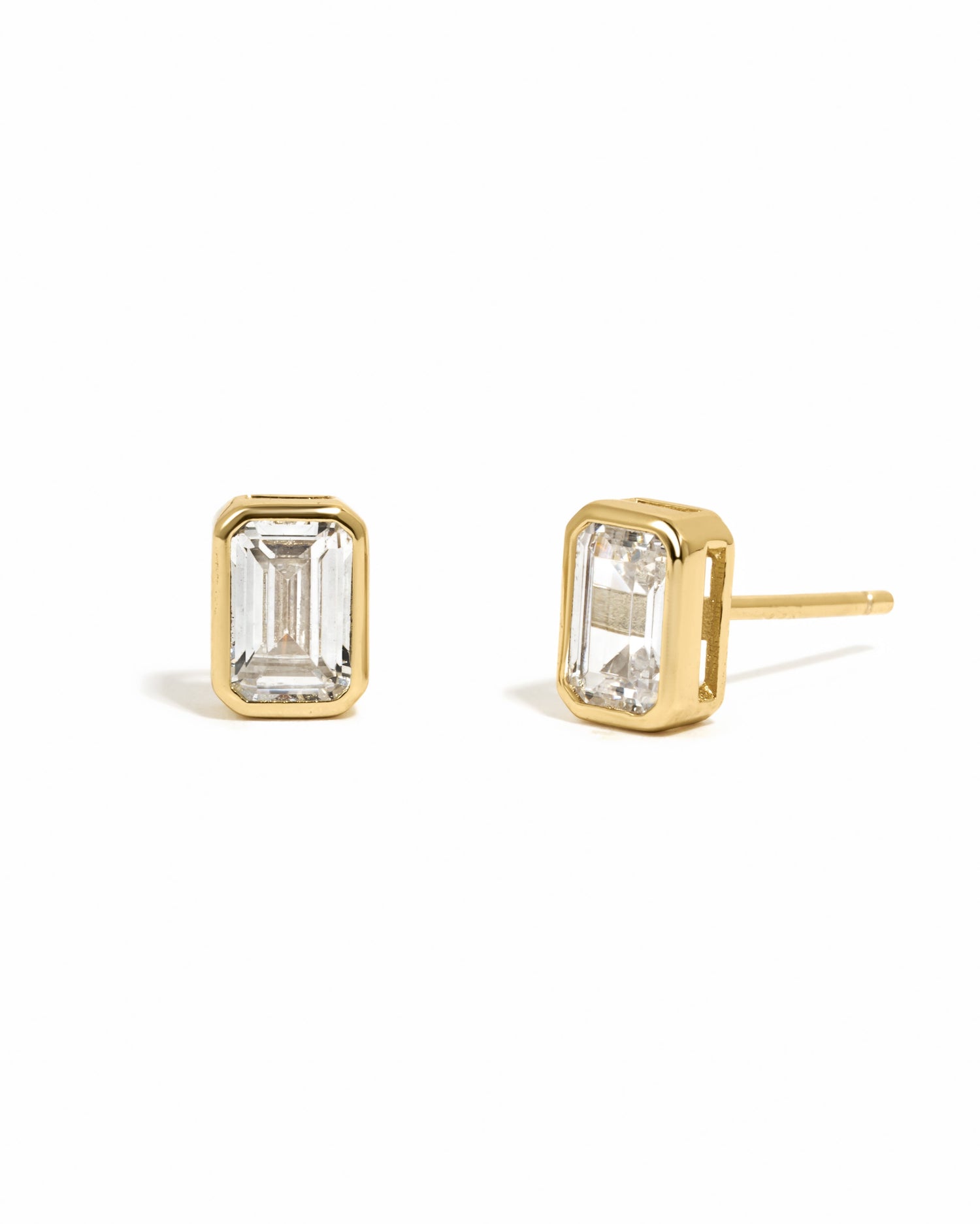 Gold emerald cut stud earrings by Sami Jewels on white background, showcasing sleek and elegant jewelry design.