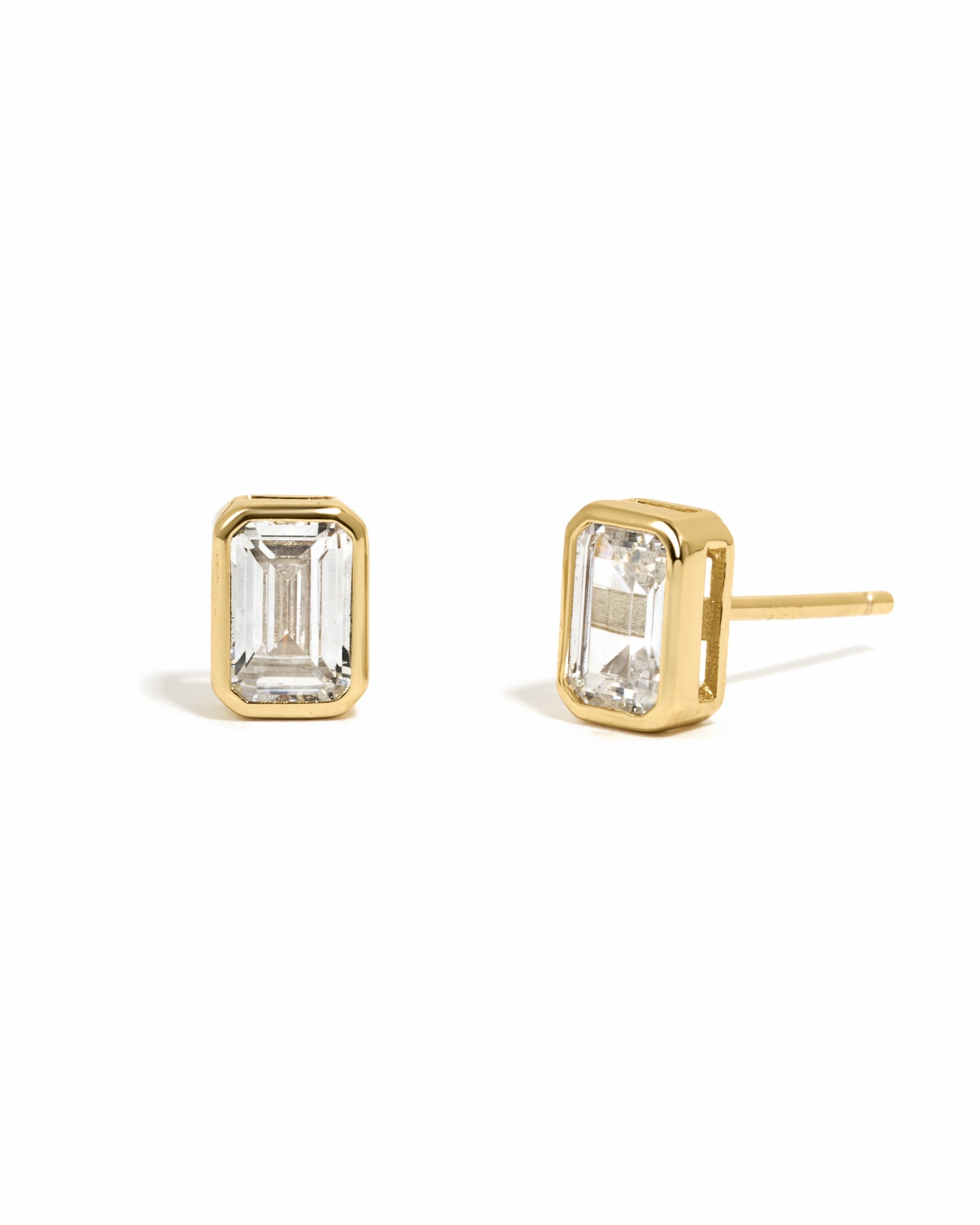 Gold emerald cut stud earrings by Sami Jewels on white background, showcasing sleek and elegant jewelry design.