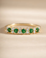 Close-up of Sami Jewels Emerald Stephanie Stacking Ring with emerald cubic zirconia in gold finish, showcasing its detailed design.