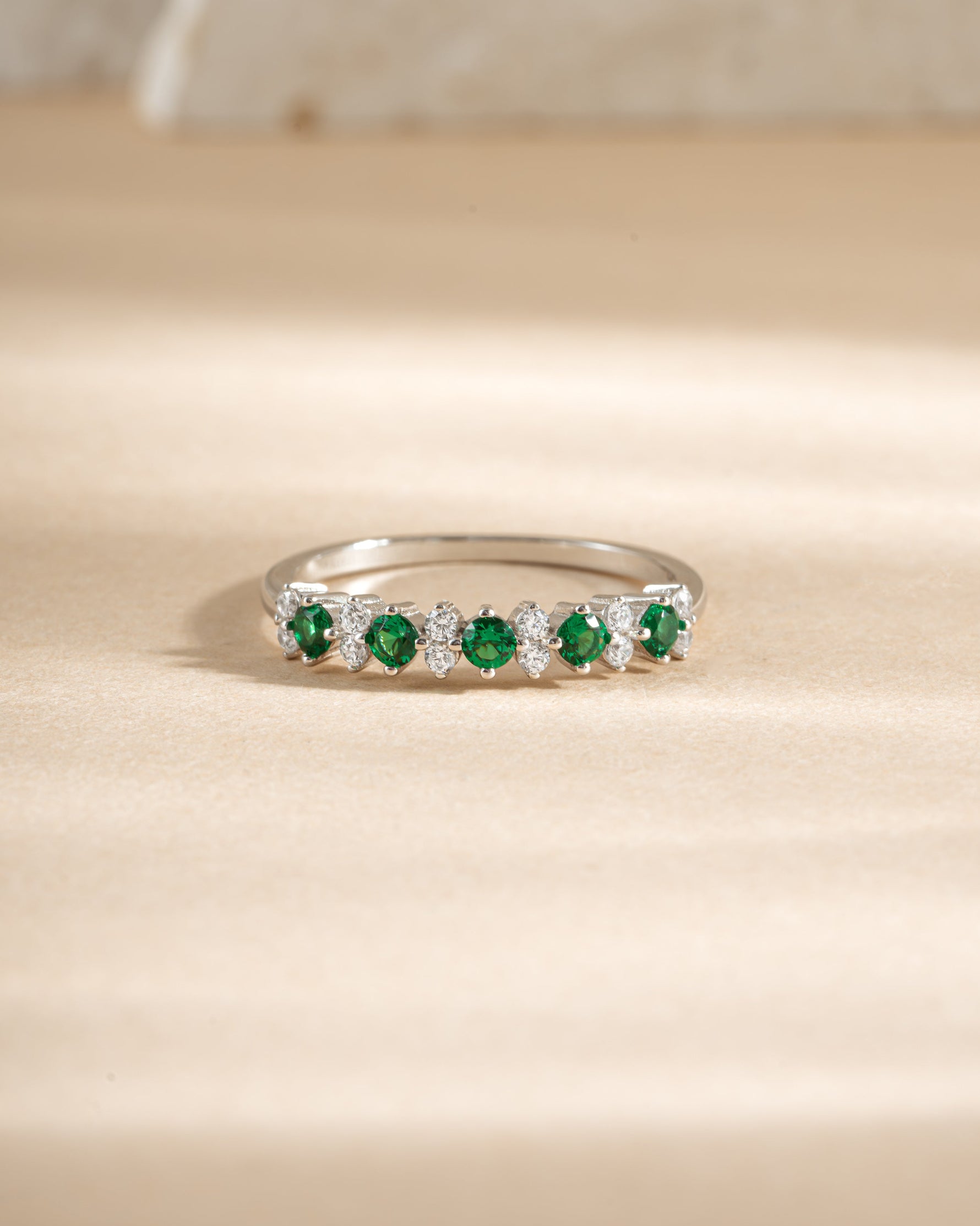 Emerald Stephanie stacking ring by Sami Jewels featuring vibrant emerald cubic zirconia set in sterling silver, front view.