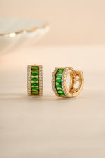 Sami Jewels emerald diamond baguette hoop earrings with gold setting, angled view showcasing elegant design and sparkling gemstones.