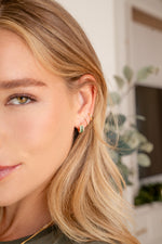Sami Jewels emerald baguette hoop earrings with diamond accents, shown on model, featuring gold huggie-style earrings.