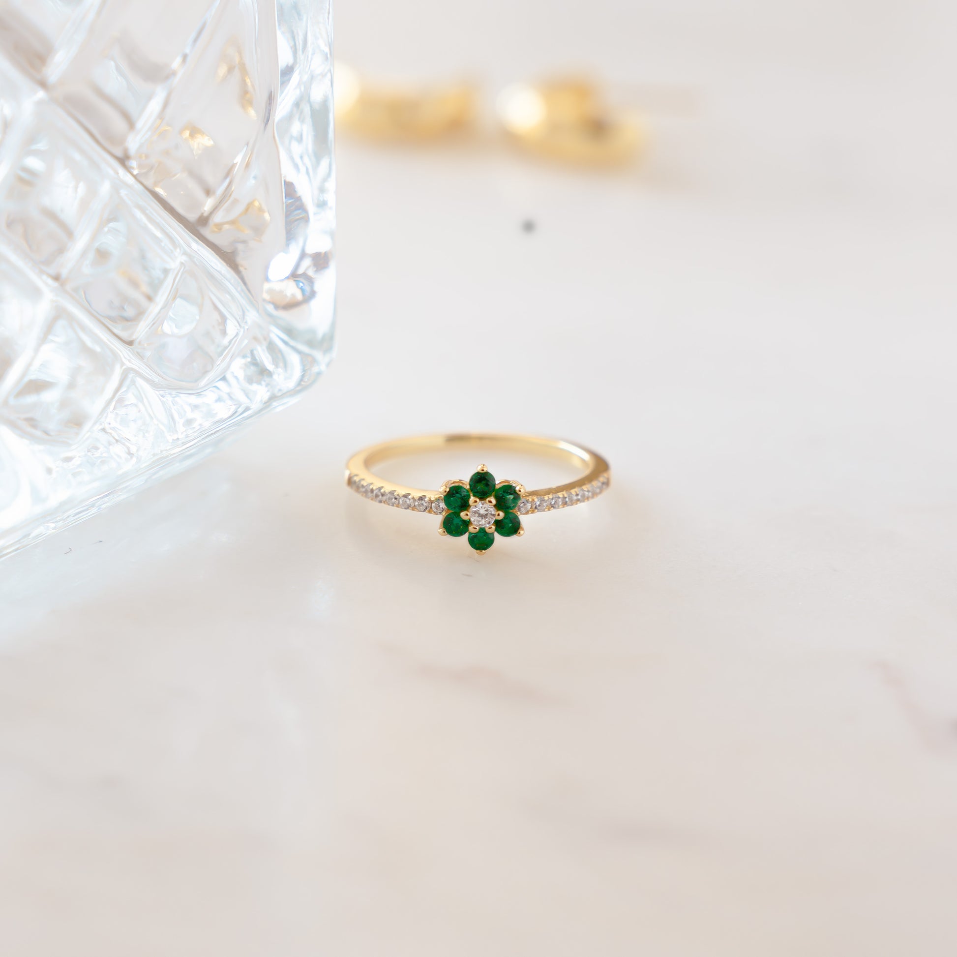 gold dainty flower ring with emerald stones