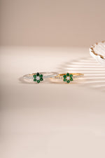 Emerald flower ring by Sami Jewels featuring a gold and sterling silver band with a detailed emerald flower design.