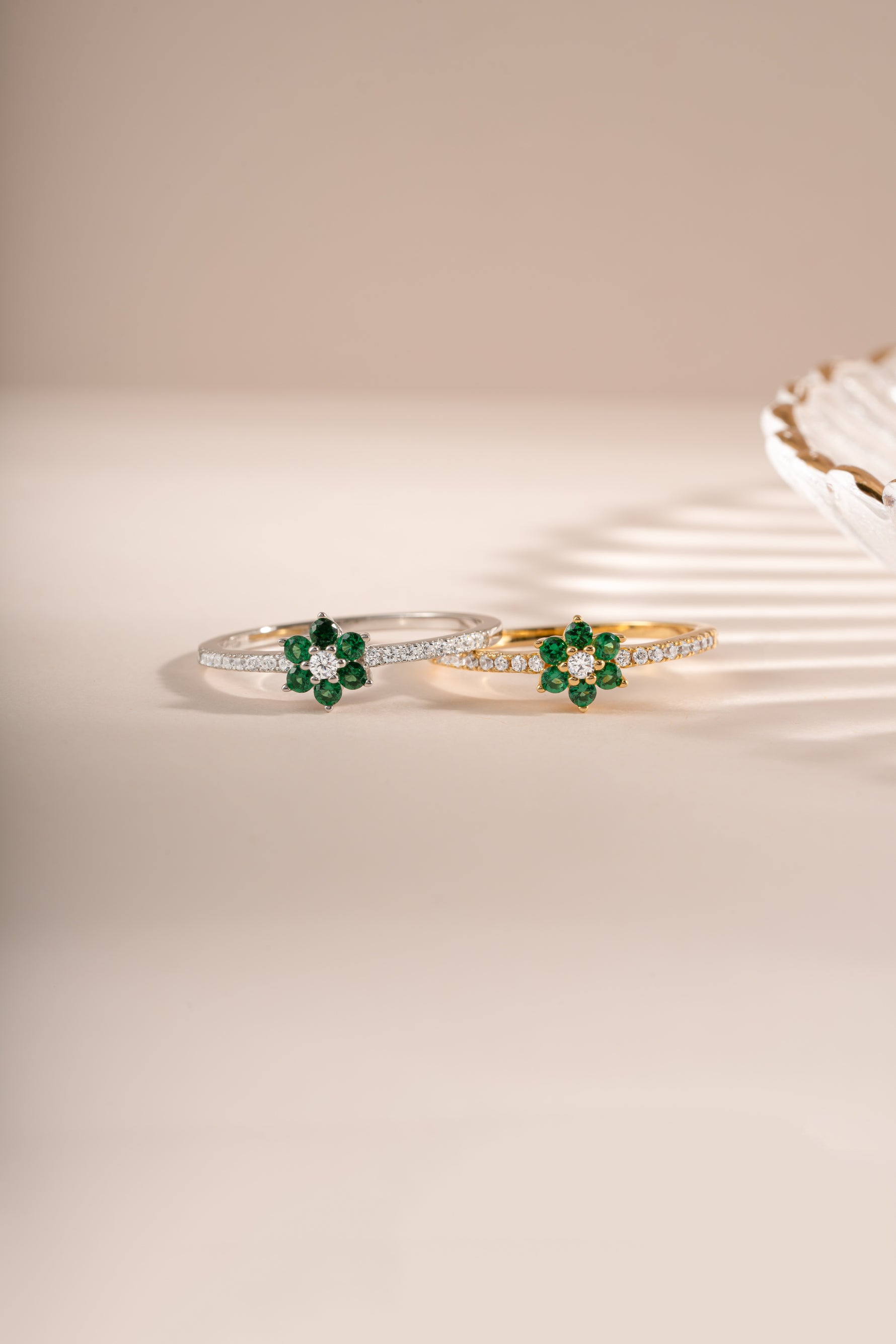 Emerald flower ring by Sami Jewels featuring a gold and sterling silver band with a detailed emerald flower design.