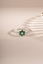 Sterling silver emerald flower ring by Sami Jewels, featuring a detailed floral design with vibrant green emerald center.