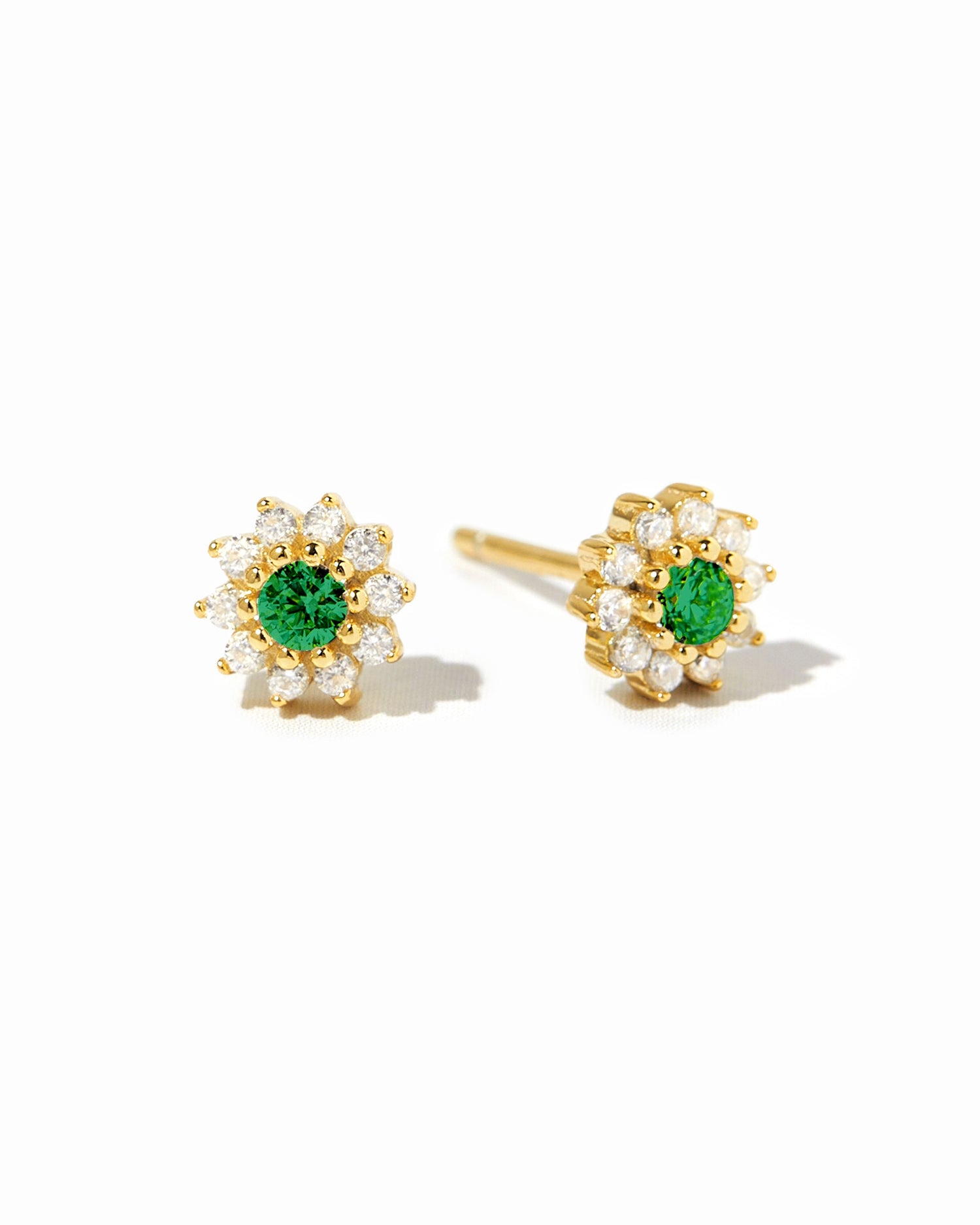 Gold emerald dainty flower stud earrings by Sami Jewels displayed on a white background.