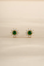 Gold emerald dainty flower stud earrings by Sami Jewels featuring delicate floral design and sparkling green gemstones.