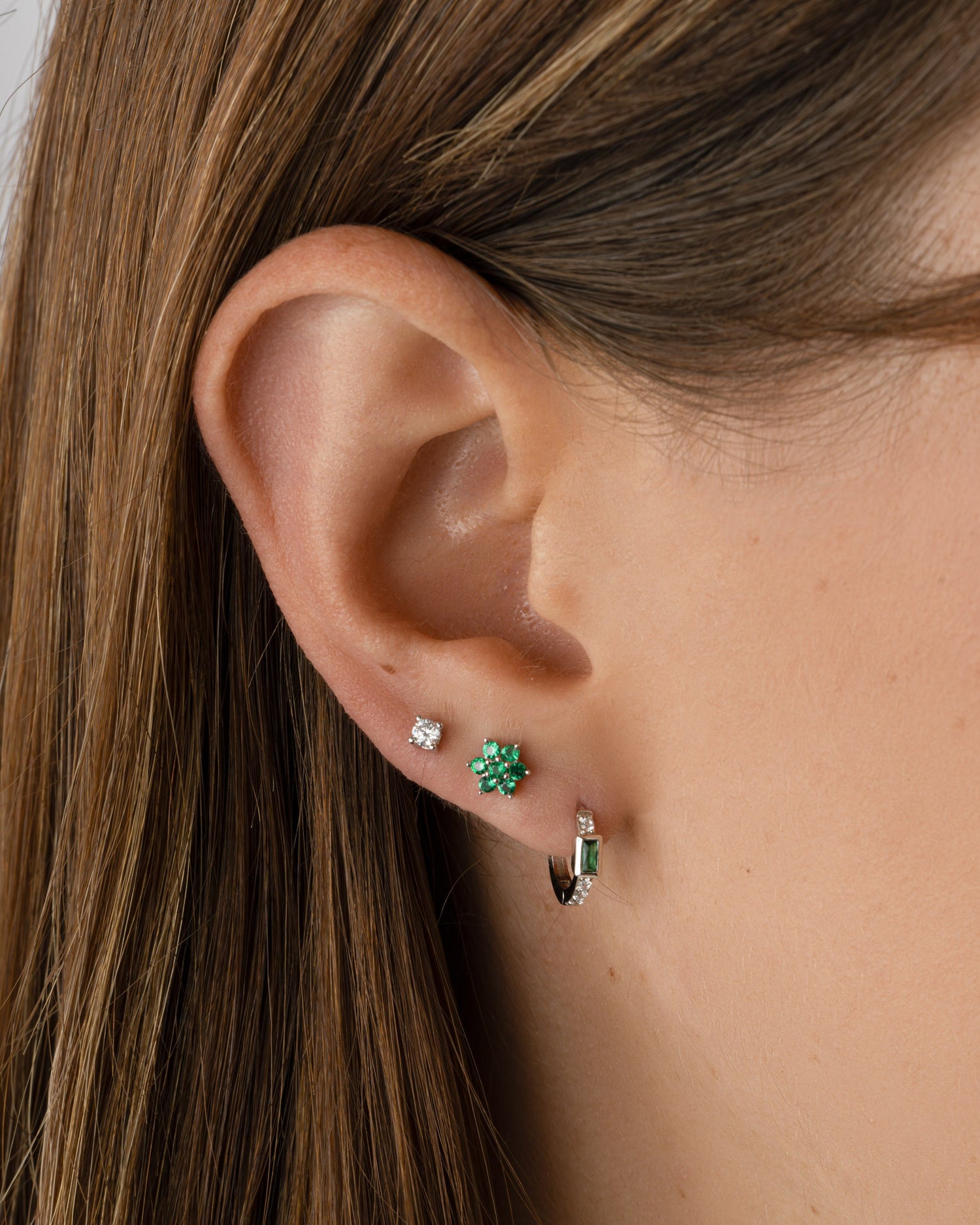 emerald flower stud earrings in sterling silver in models second hole piercing