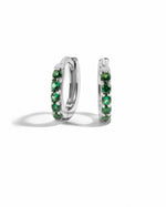 Sterling silver 7mm emerald huggie earrings with vibrant green gemstones, showcasing elegant jewelry design.