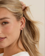 emerald three stone huggie hoop earring in gold on women 