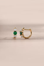 emerald three stone huggie hoop earring in gold side view