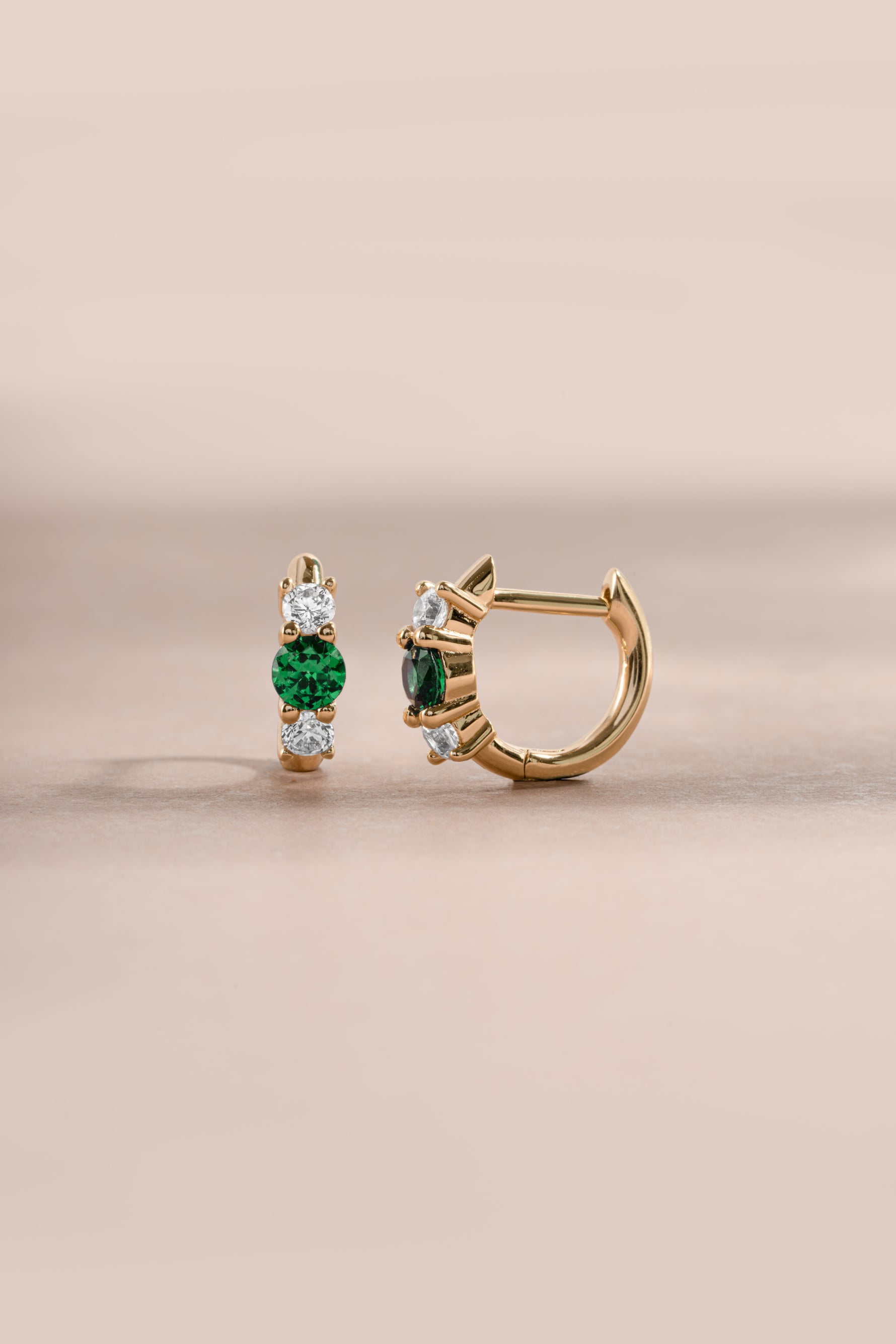 emerald three stone huggie hoop earring in gold side view