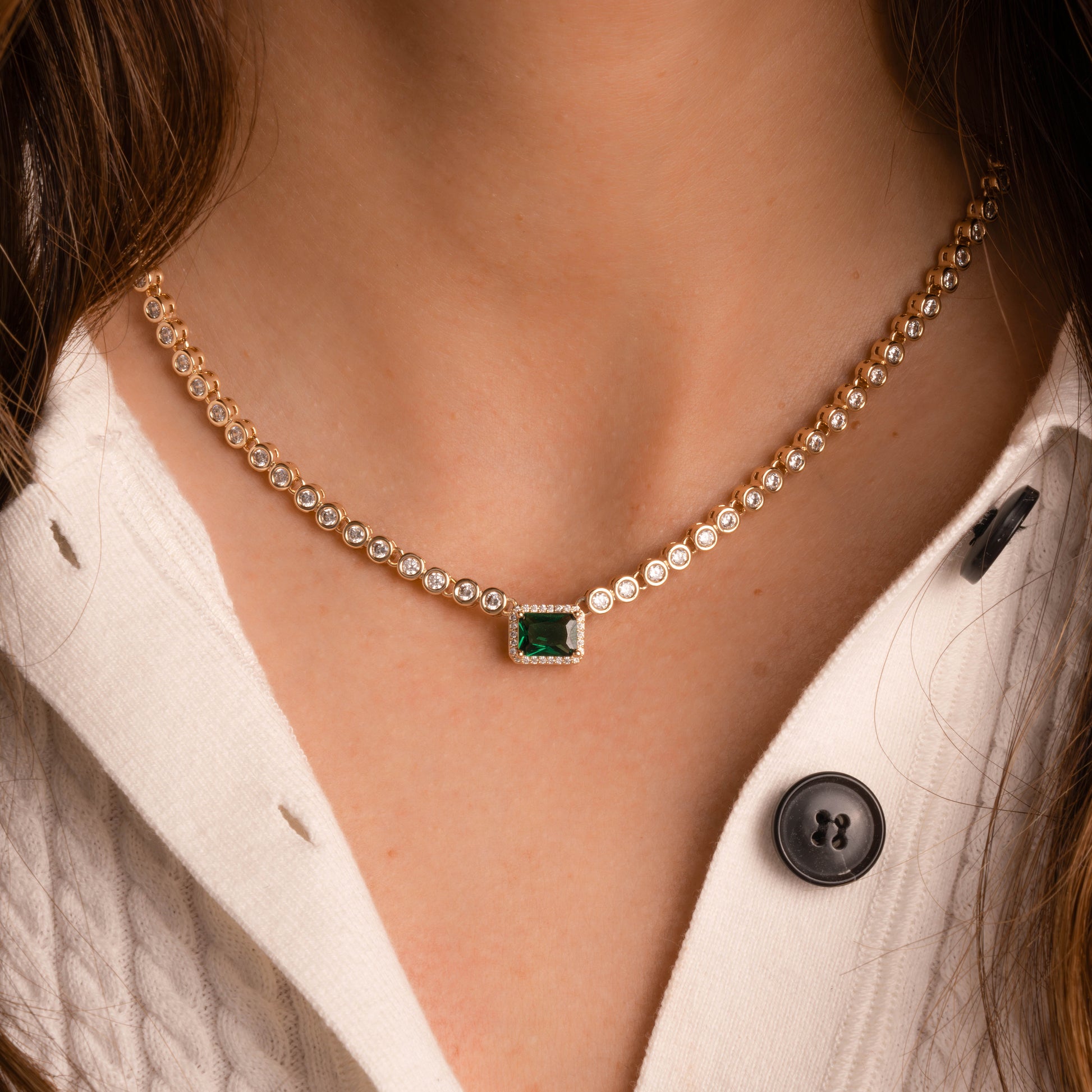 Emerald diamond necklace on model, with tiny diamonds and large emerald stone pendant