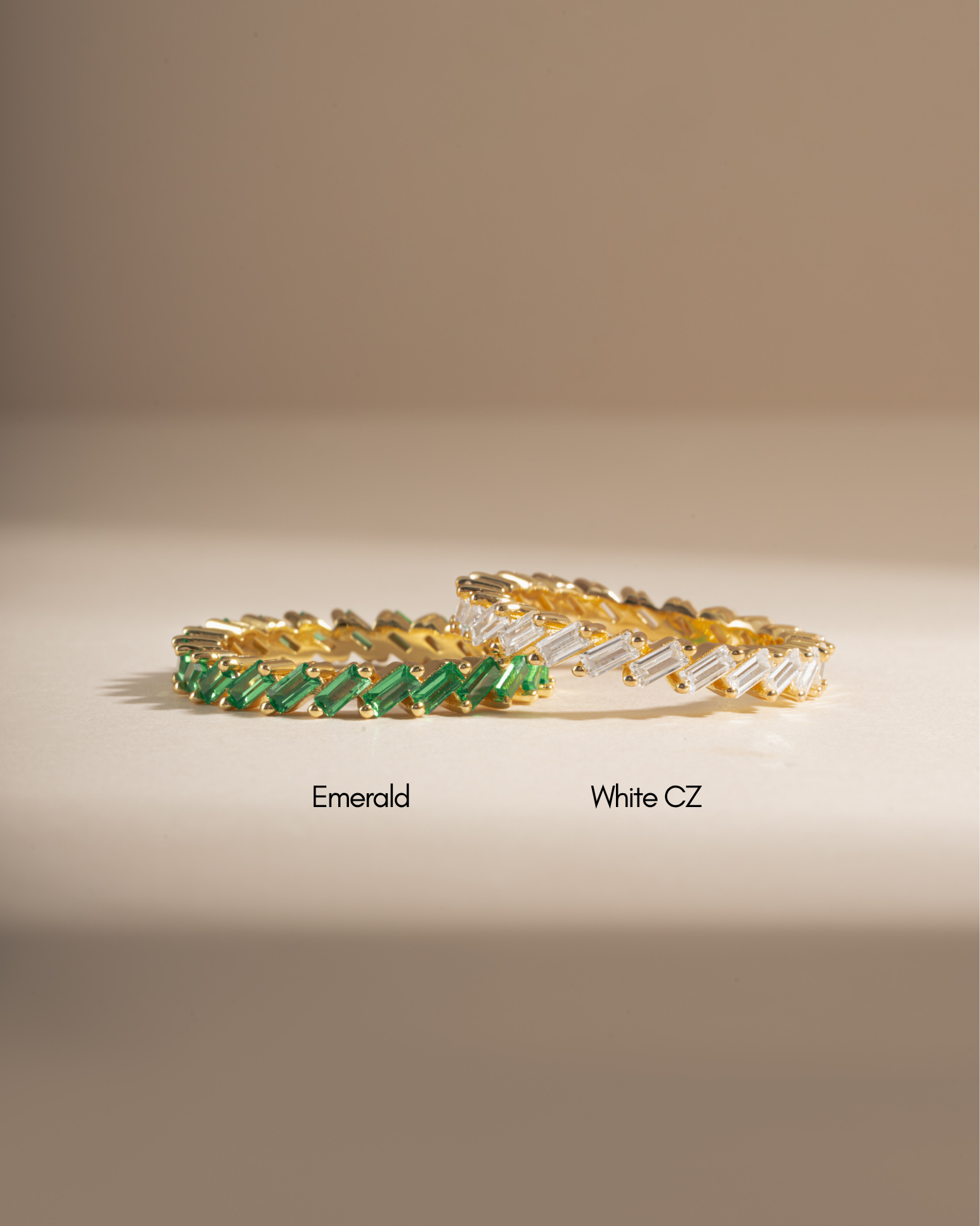Sami Jewels emerald slanted baguette ring with white CZ baguette accents, showcasing elegant jewelry design.