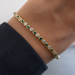 model wearing emerald green and white cz tennis bracelet