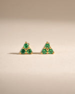 Sami Jewels Tiny Emerald 3 Stone Stud Earrings featuring three vibrant emerald gemstones set in gold, front view.