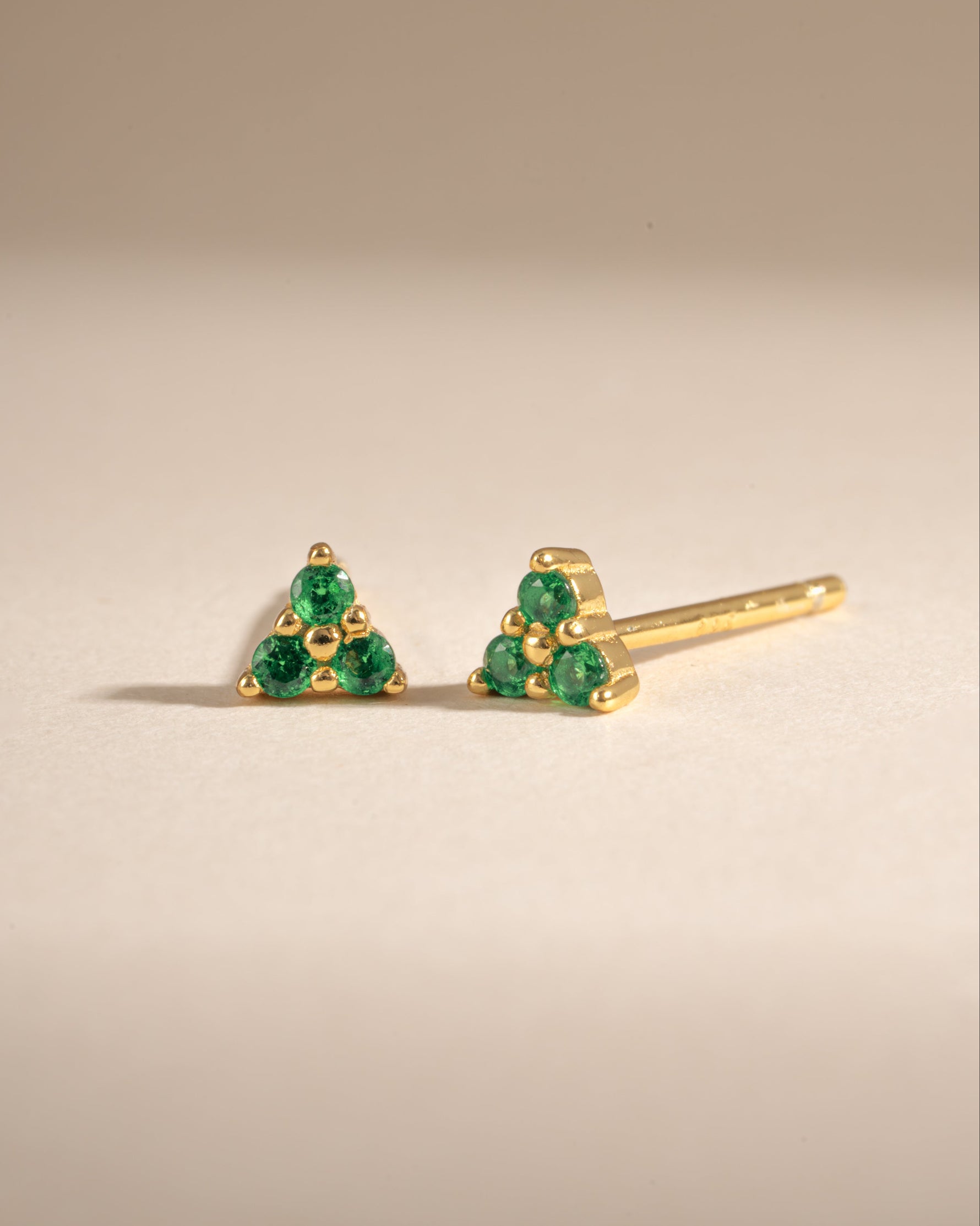 Gold Tiny Emerald 3 Stone Stud Earrings by Sami Jewels, side view showing sparkling green gemstones and delicate setting.