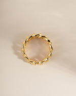 White enamel chain ring by Sami Jewels, featuring a sleek design with gold accents, viewed from the top.