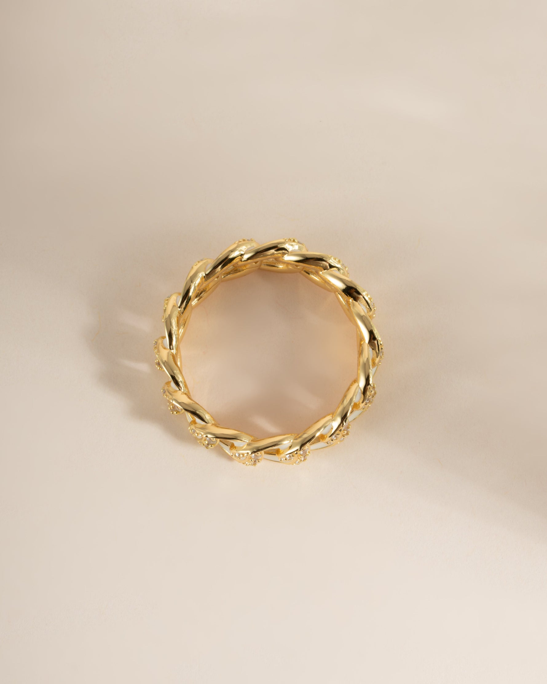 White enamel chain ring by Sami Jewels, featuring a sleek design with gold accents, viewed from the top.