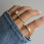 model wearing a ring stack, 14k gold rings are paired beautifully for a trendy, layered look. 