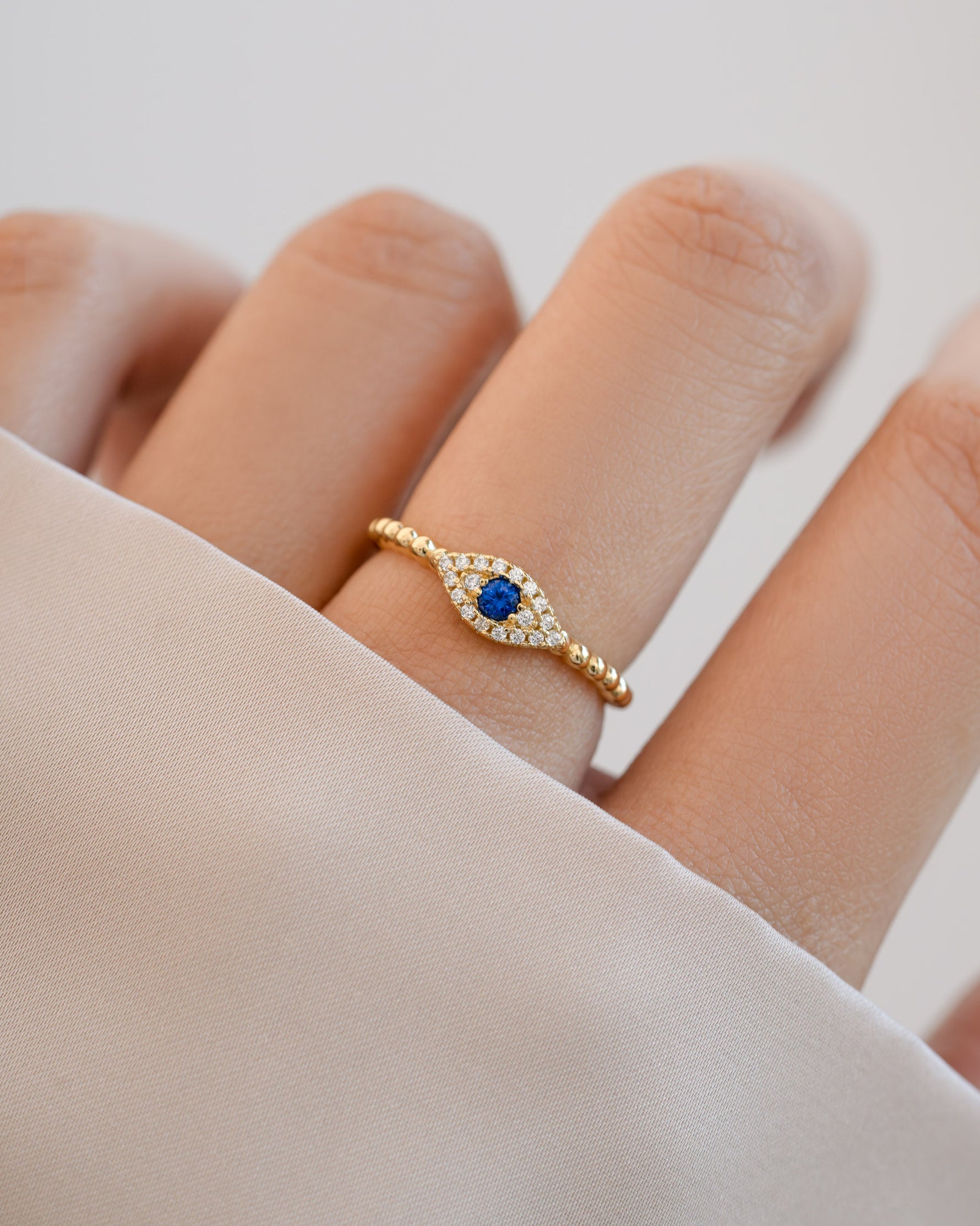 adjustable evil eye ring in gold on model