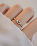 adjustable evil eye ring in rose gold on models hand