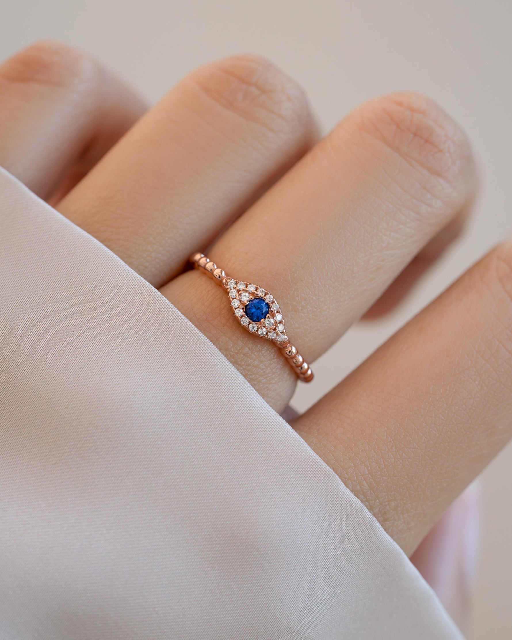 adjustable evil eye ring in rose gold on models hand