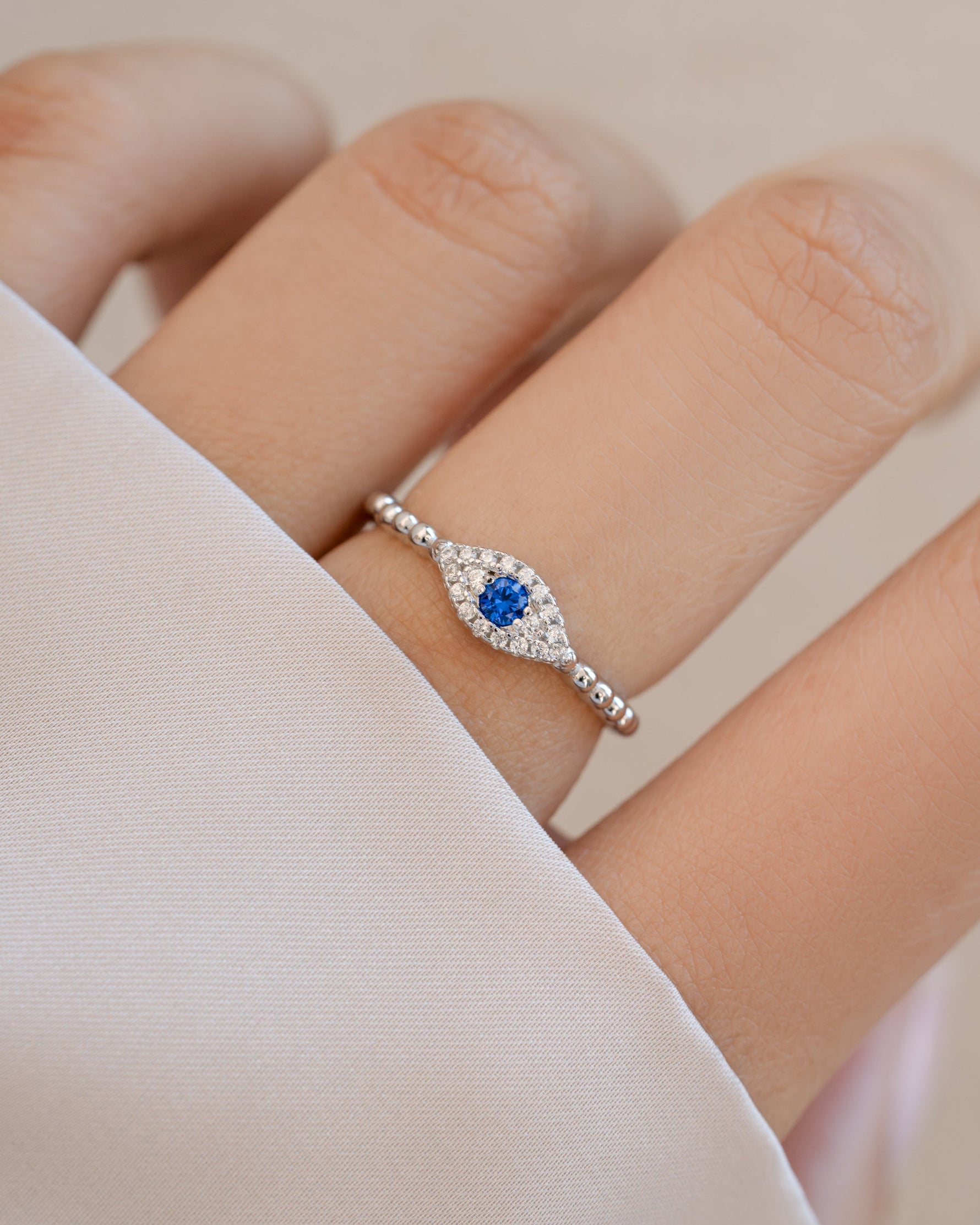 adjustable evil eye ring in sterling silver on models hand