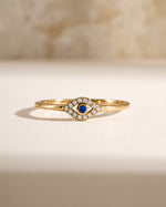 Tiny blue evil eye ring by Samijewels-527, gold ring featuring a blue evil eye charm, front view showcasing intricate design.
