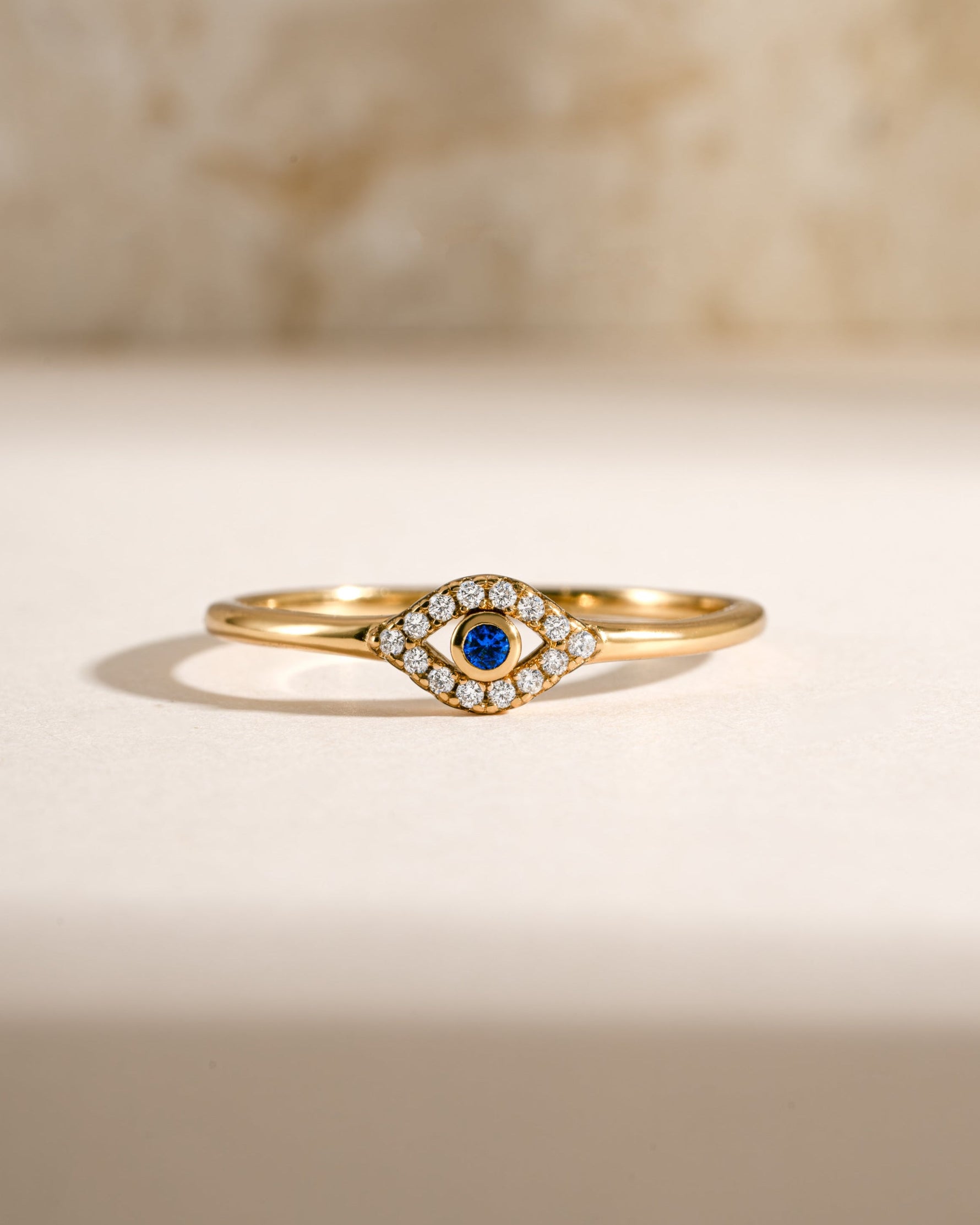 Tiny blue evil eye ring by Samijewels-527, gold ring featuring a blue evil eye charm, front view showcasing intricate design.