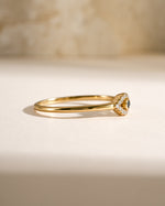 Side view of Samijewels-527 tiny blue evil eye ring in gold, showcasing its delicate design and detailed evil eye charm.