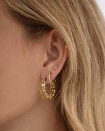 Gold filigree tapered hoop earrings by Sami Jewels, featuring intricate openwork design on lightweight hoop earrings.