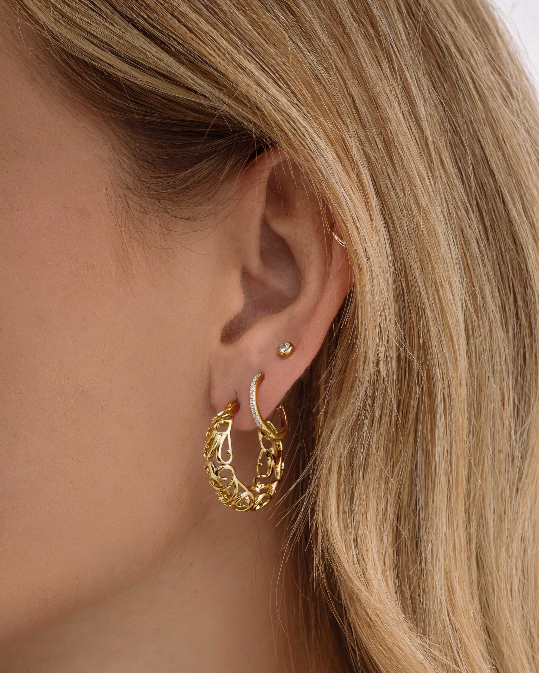 Gold filigree tapered hoop earrings by Sami Jewels, featuring intricate openwork design on lightweight hoop earrings.