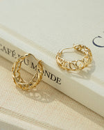 Gold filigree tapered hoop earrings by Sami Jewels showing intricate lace-like metalwork and a tapered design.