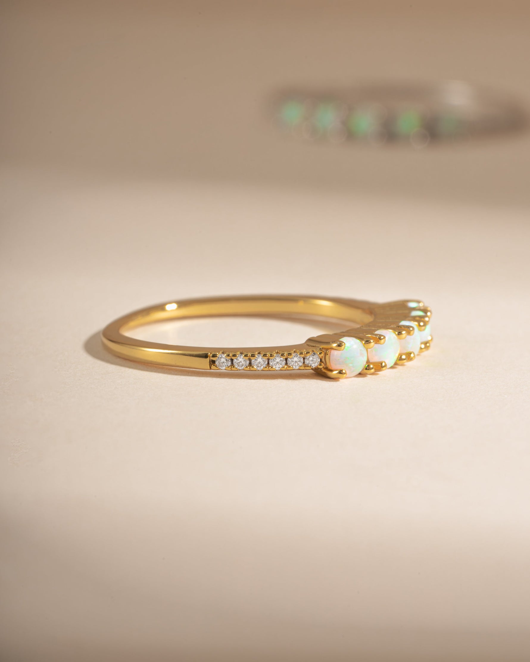 Gold 5-stone opal ring from Sami Jewels, side view showcasing vibrant opal stones and elegant band design.