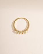 Gold five-stone opal ring by Sami Jewels, top view showing vibrant multi-colored opal stones set in elegant band.