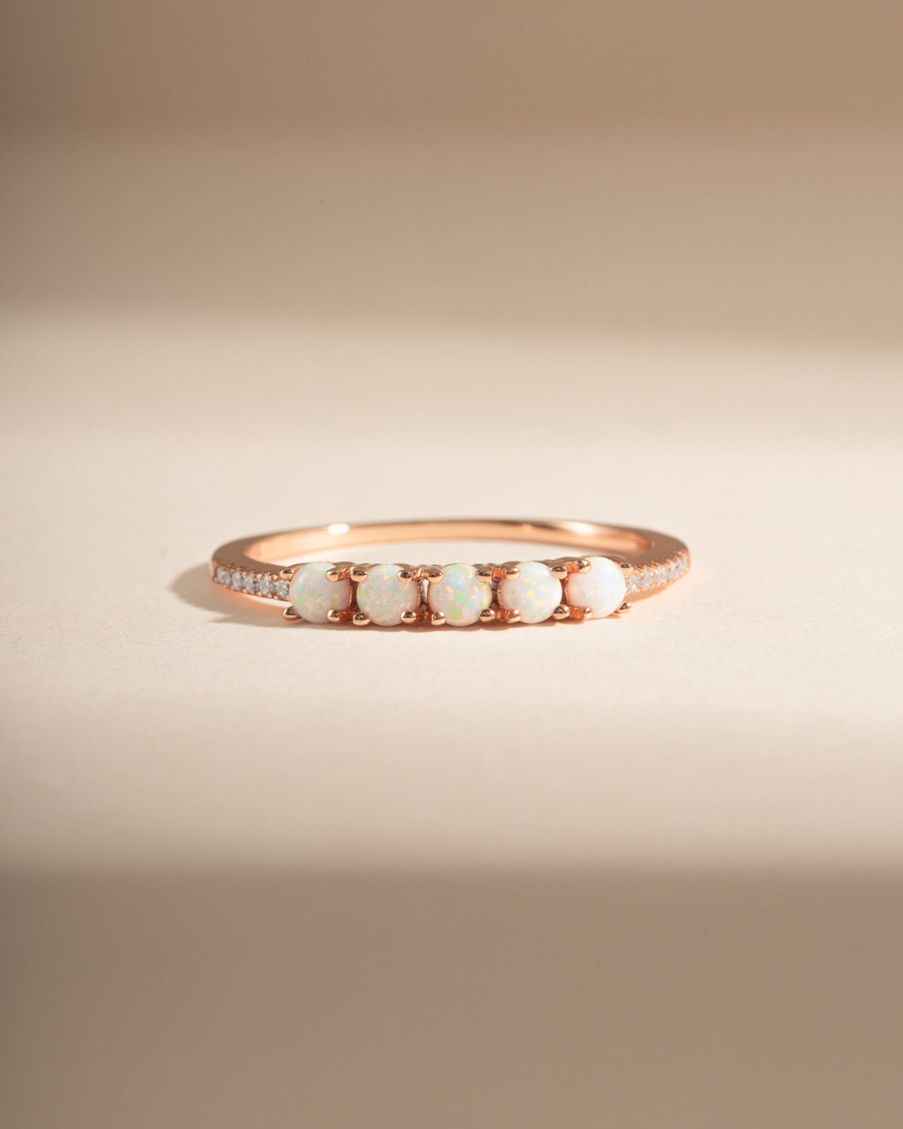 Sami Jewels 5-stone opal ring with rose gold band featuring five vibrant opal gemstones arranged in a elegant design.