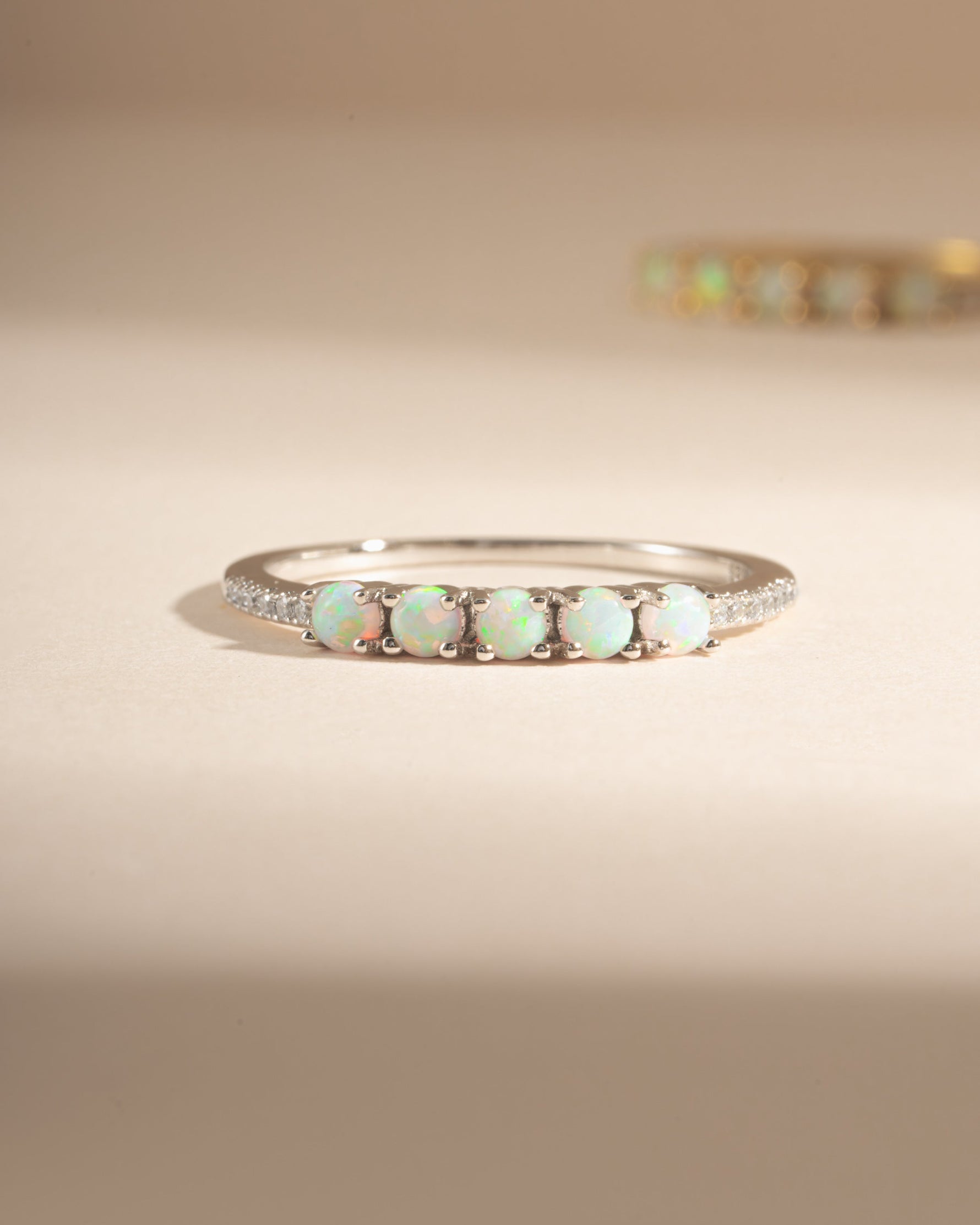 Sami Jewels 5-stone opal ring featuring sterling silver band with vibrant, multicolored opal stones across the front.