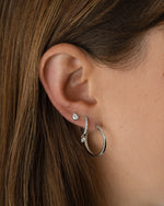 Sterling silver 18mm flat hoop earrings by Sami Jewels shown on a model, showcasing sleek, minimalist jewelry design.