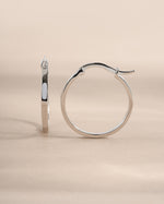 Sterling silver 18mm flat hoop earrings from Sami Jewels, side view showing sleek, minimalist design.