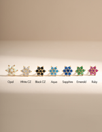 Gold sapphire flower earrings by Samijewels-527 featuring colorful gemstone-studded flower studs, close-up view of the jewelry.