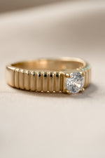 Gold fluted solitaire CZ ring from Sami Jewels, angled view showcasing the detailed band and sparkling central stone.