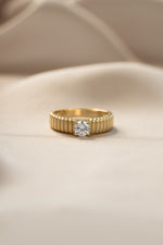 Gold fluted solitaire CZ ring from Sami Jewels featuring a prominent central stone and intricate fluted band design.