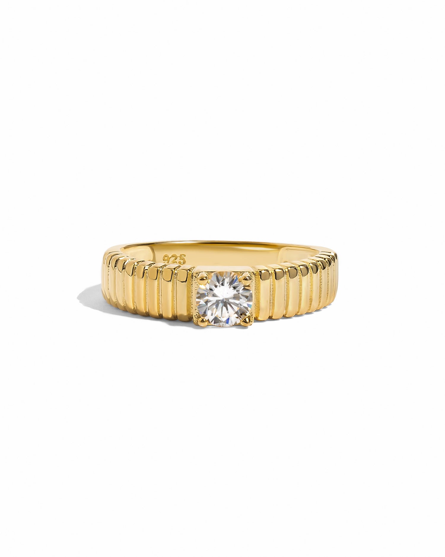 Gold fluted solitaire CZ ring by Sami Jewels with a smooth band and sparkling central stone on a white background.