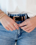 Gold fluted solitaire CZ ring with a sleek band, showcased on a model, from Sami Jewels.