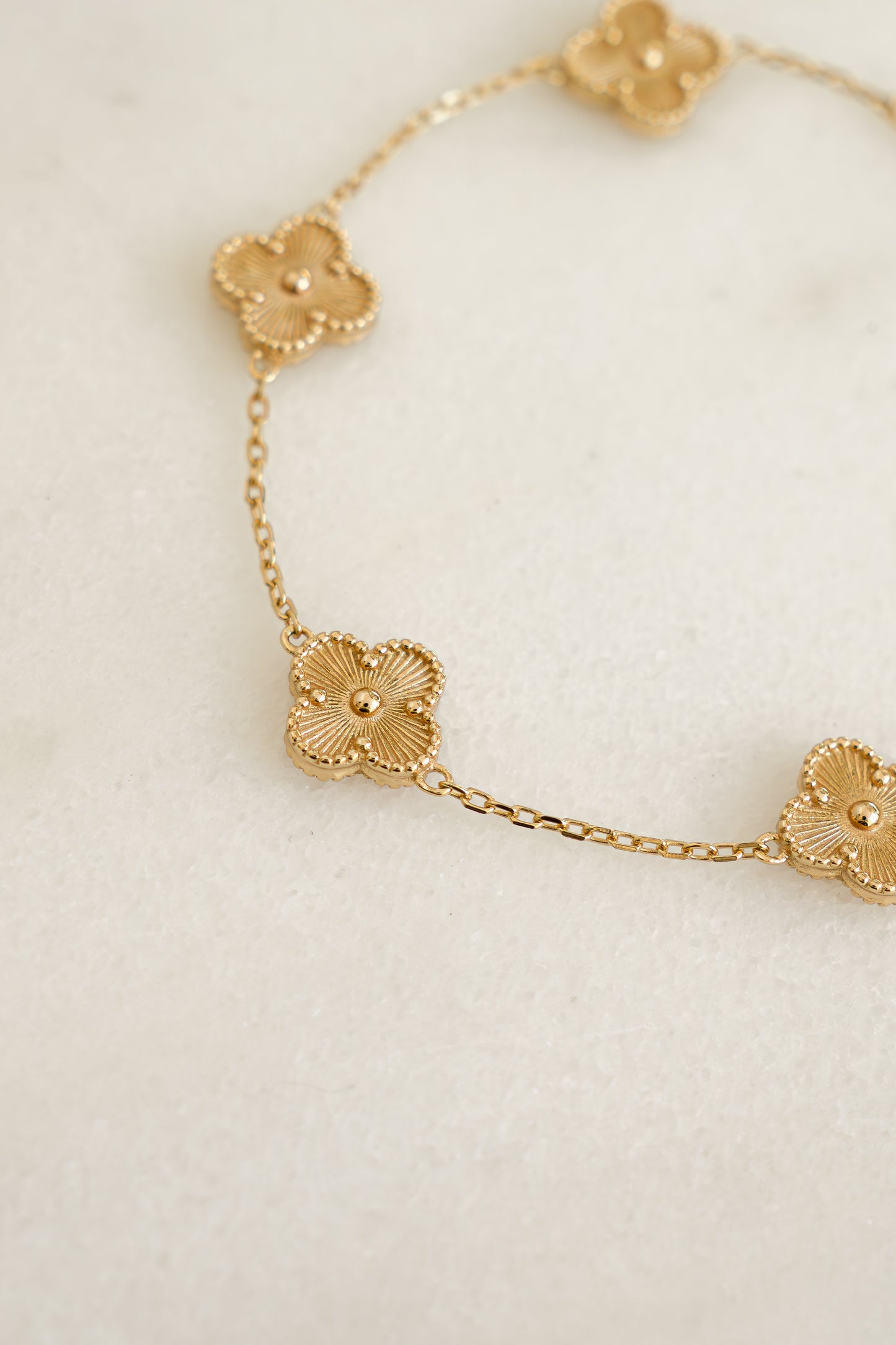 close up of the intricate details of the four leaf clover charm bracelet